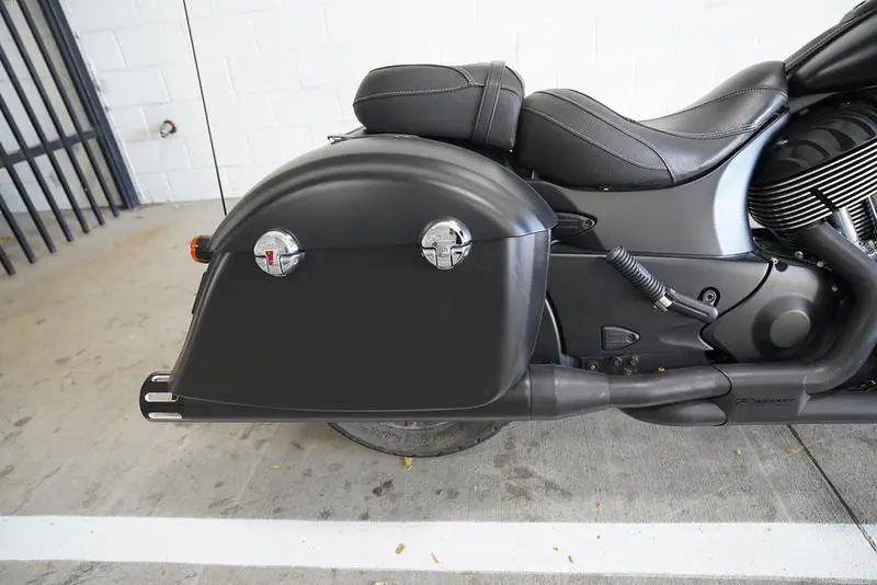 Close-up view of the saddle bags on a black Indian Motorcycle parked outside Moto United dealership
